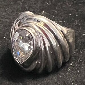 100% sterling silver scalloped ring with CZ. It’s a conversation piece.